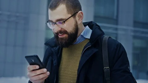 Man using smartphone smiling Stock Footage 71982186