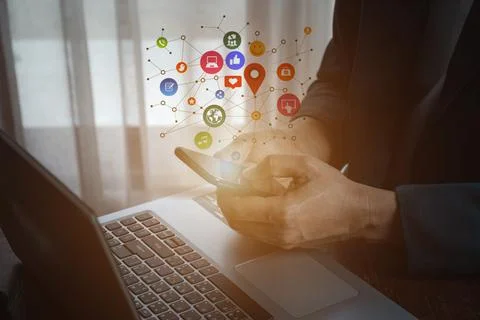 Man using smartphone with social web icon popup on the phone Stock Photos