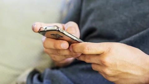 Man using a smartphone, soft focus. Stock Photos
