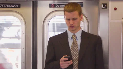 Man Using Smartphone in Subway - Above Ground Vídeos de archivo 22760349