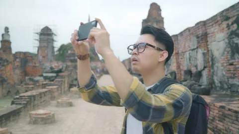 Man using smartphone for take a picture holiday trip at Ayutthaya, Thailand, Stock Footage 101889981