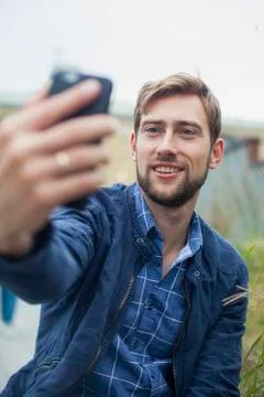 Man using smartphone to take a selfie Stock Photos