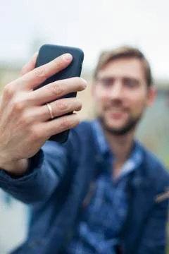 Man using smartphone to take a selfie Stock Photos