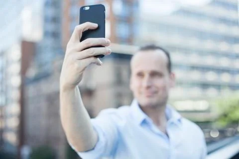 Man using smartphone to take a selfie Stock Photos