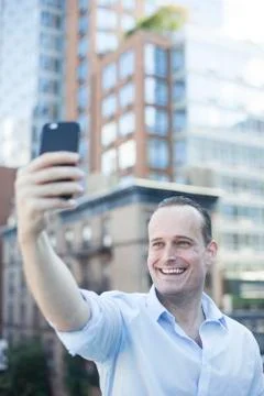 Man using smartphone to take a selfie Stock Photos