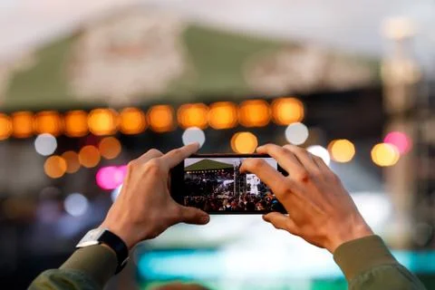 Man using smartphone to take a video at a concert Stock Photos