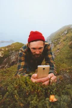 Man using smartphone taking photo of cloudberry walking outdoor modern techno Stock Photos
