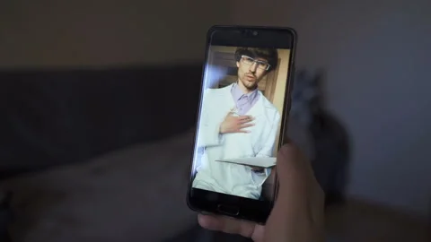 Man Using Smartphone to Talk to His Doctor via Video Conference Medical App Stock Footage 144621326