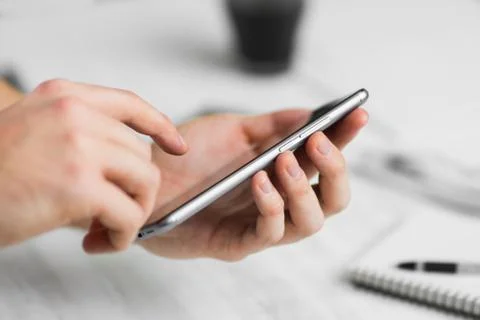 Man using smartphone a touch screen smart phone hands in cafeclose up, vintag 스톡 사진