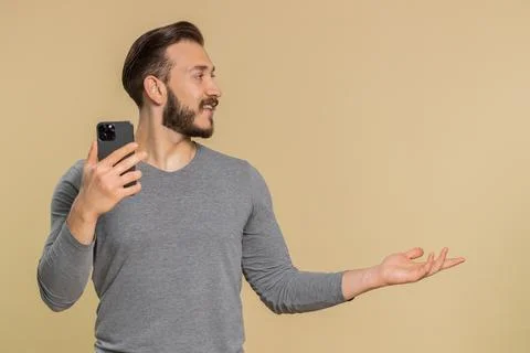 Man using smartphone typing new post on web, browsing, searching pointing empty 스톡 사진