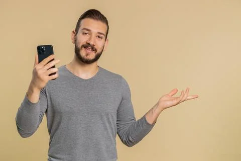 Man using smartphone typing new post on web, browsing, searching pointing empty 스톡 사진