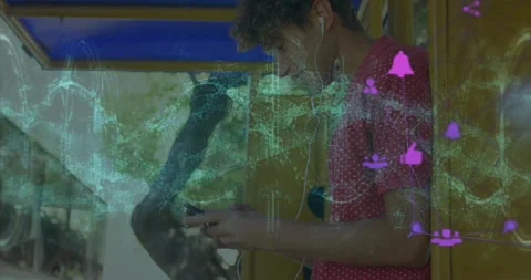 Man using smartphone under yellow transit shelter, showing floating tech icons Stock-Footage 307449621