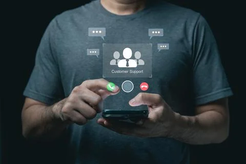 Man using smartphone with virtual customer support hologram and communicati.. Fotos de archivo