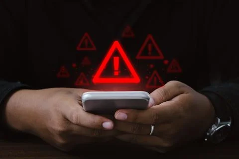 Man using smartphone with warning sign.Notification error and virus detecti.. Stock Photos