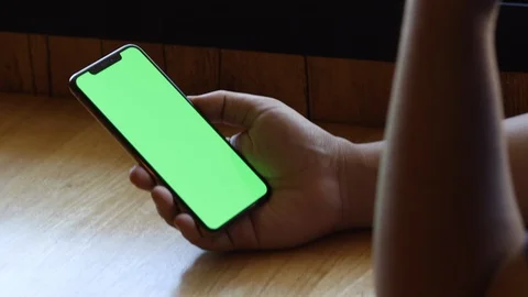 Man using smartphone watching green screen on mobile phone browsing 4k Stock Footage 122197564