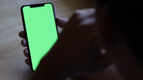 Man using smartphone watching green screen on mobile phone browsing 4k Stock Footage 122565894