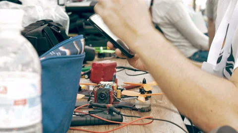 Man using smartphone while assembling FPV drone Stock Footage 67957004