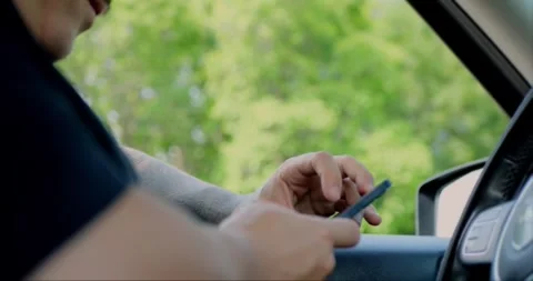 Man using smartphone while seated comfortably inside a car. Stock Footage 313951175
