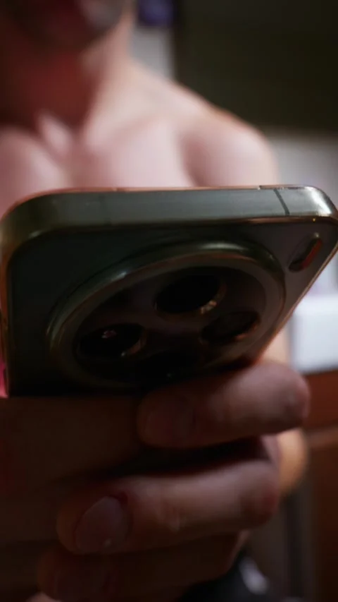 Man Using Smartphone While Sitting on Toilet in Dark Bathroom Stock Footage 339211225