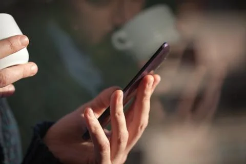 Man using smartphone from a window Stock Photos