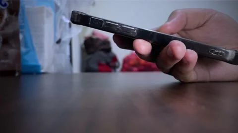 Man using smartphone on wooden table 스톡 동영상 155439345