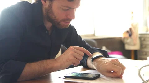 Man using smartwatch and smartphone at the same time Stock Footage 63298307