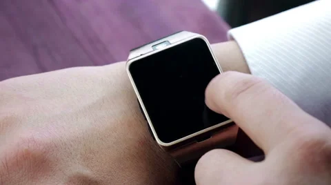 Man using smartwatch app with his finger on wood table, new technology Stock Footage 66299211
