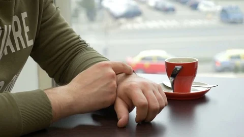 Man using smartwatch at coffee shop in the city Stock Footage 74890624
