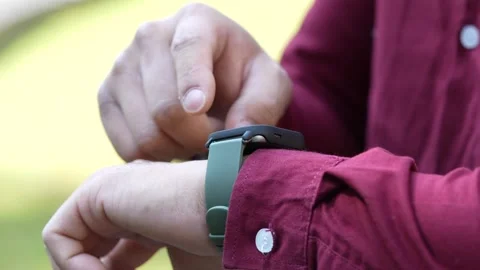 Man is using a smartwatch on his left wrist Stock Footage 335199988