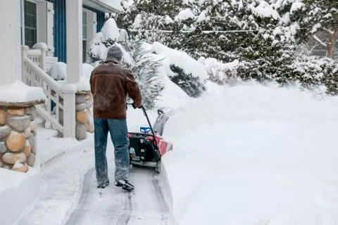 Man using snowblower in deep snow Stock Photos