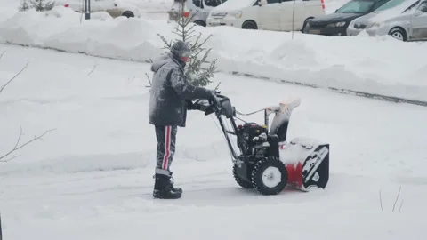 Man using snowblower machine after heavy snowfall Vídeo Stock 228897344
