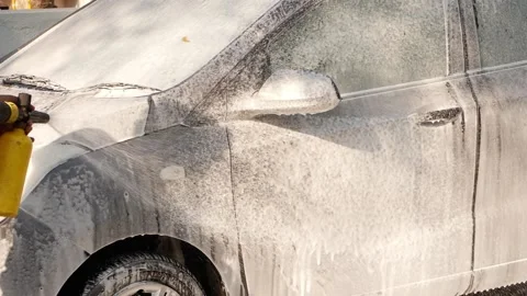 Man using soap machine to clean a black color car Stock Footage 148263434