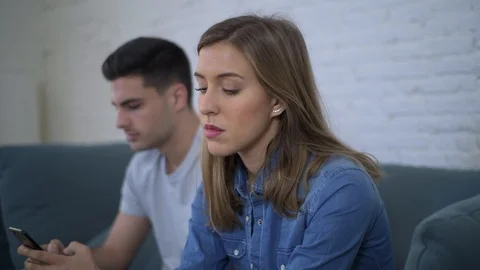 Man using social media on mobile phone ignoring his girlfriend Stock Footage 87333015