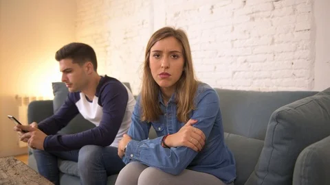 Man using social media on mobile phone ignoring his girlfriend Stock Footage 87336186