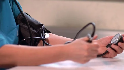 Man using a sphygmomanometer for blood pressure Stock Footage 125895622