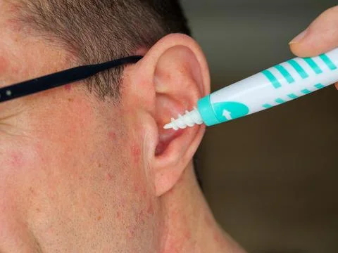 Man Using Spiral Ear Cleaner Tool Close Up Stock Photos