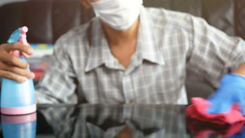 Man using spray bottle with sterilizing solution make cleaning and disinfection Stock Footage 131827375