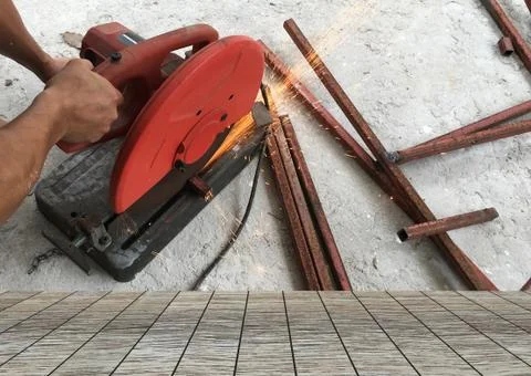 Man using steel cutters work and wood floor space for your product Stock Photos