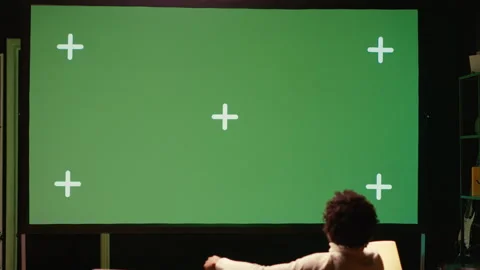 Man using streaming services on ultrawide chroma key TV to binge watch series Stock Footage 262012060