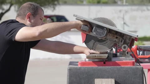 Man using a table saw to cut wood for a garden playground project Stock Footage 279183951