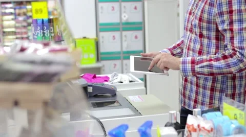 Man using a tablet and the credit card in store Stock Footage 63982231