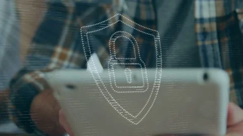Man using tablet and tapping screen causing animated security shield over tablet Stock Footage 335761979