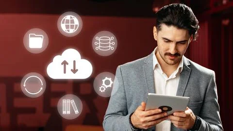Man using tablet with cloud and data icons in a modern setting during the day Stock Photos