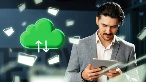 Man using tablet with cloud storage symbol in modern office setting Stock Photos