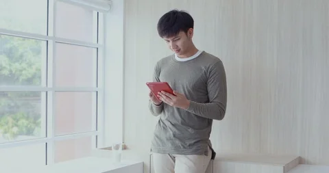 Man using tablet computer and drinking milk. Stock Footage 128487555