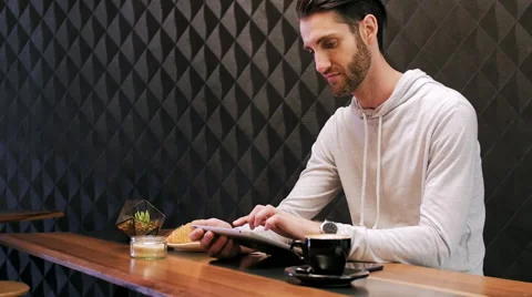 Man using tablet computer in cafe Stock Footage 58124971