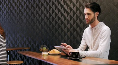 Man using tablet computer in cafe Stock Footage 58125594