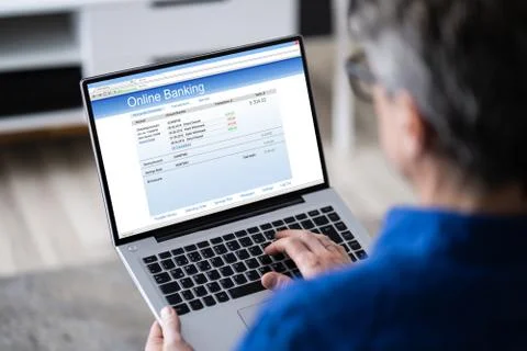 Man Using Tablet Computer Checking Bank Statement Stock Photos