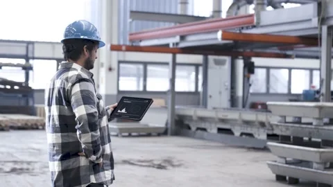 Man using a tablet computer in an industrial hall Stock Footage 149294651