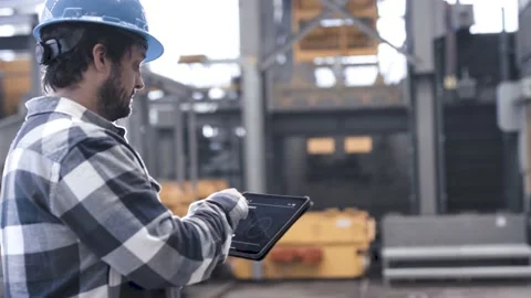 Man using a tablet computer in an industrial hall Stock Footage 149294731